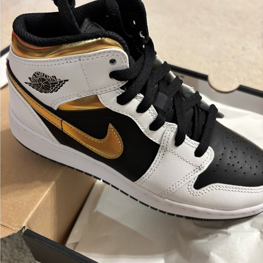Nike Air Jordan Black, White, and Gold High Tops